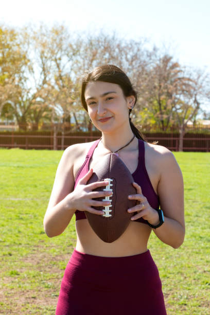 istock A girl holding a football ball 1389964458