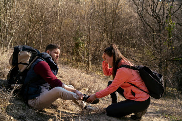 istock Man twists his ankle, during the hiking in the forest mountains 1389966343