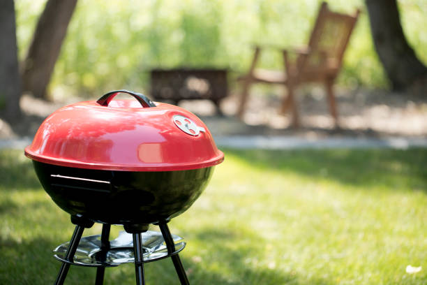 Red Generic Brand Barbecue Grill in the backyard.