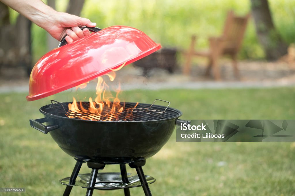 Barbecue Grill in the Backyard Red Generic Brand Barbecue Grill in the backyard. Barbecue Grill Stock Photo