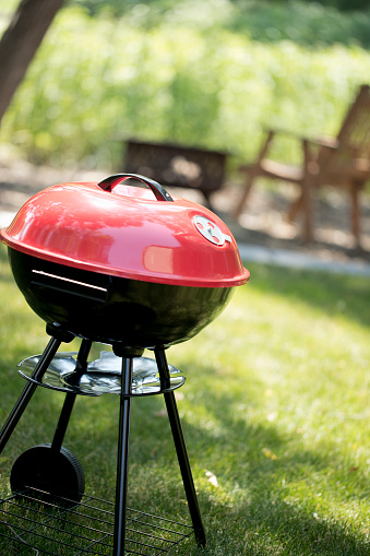 Red Generic Brand Barbecue Grill in the backyard.