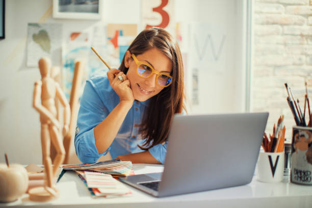 istock Young woman designer working in her home studio 1389969541