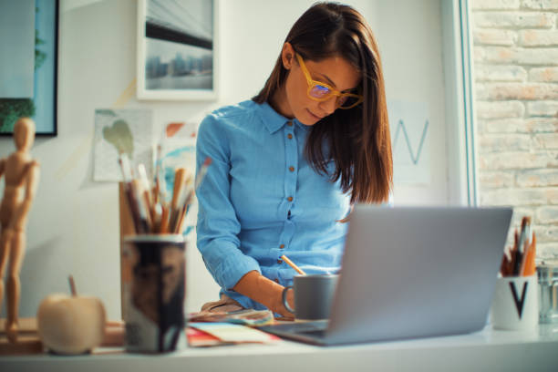 istock Young woman designer working in her home studio 1389969575