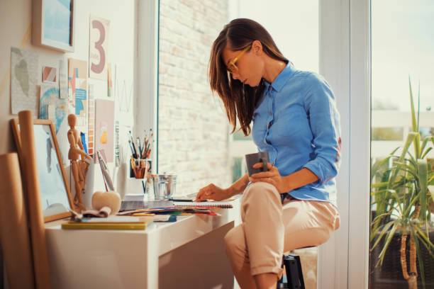 istock Young woman designer working in her home studio 1389969643