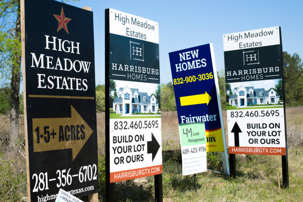 Home builder's advertisements on the side of the road in sought after properties in the area of Bobo's Crossing near Magnolia, Texas. stock photo