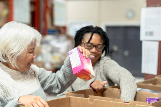 istock Seniors Packing Boxes at a Food Bank 1389973539