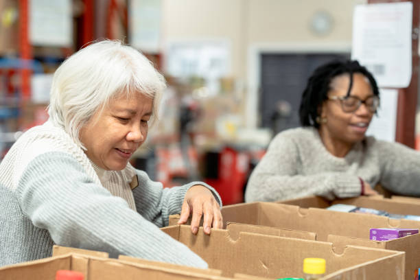 istock Seniors Packing Boxes at a Food Bank 1389973548