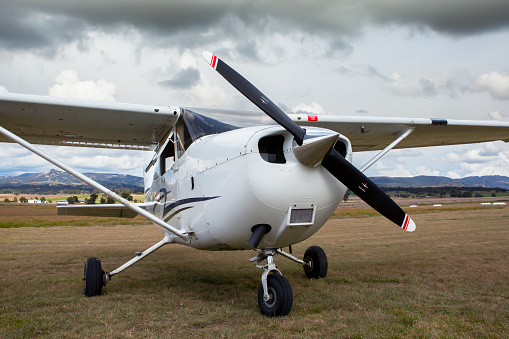 This image is of a Cessna 172 Skyhawk parked on a remote strip in New South Whales. The Cessna 172 Skyhawk is equipped with 2 15 inch Garmin G1000 screens. The Cessna 172 Skyhawk is an American four-seat, single-engine, high wing, fixed-wing aircraft made by the Cessna Aircraft Company. First flown in 1955, more 172s have been built than any other aircraft. It was developed from the 1948 Cessna 170 but with tricycle landing gear rather than conventional landing gear.