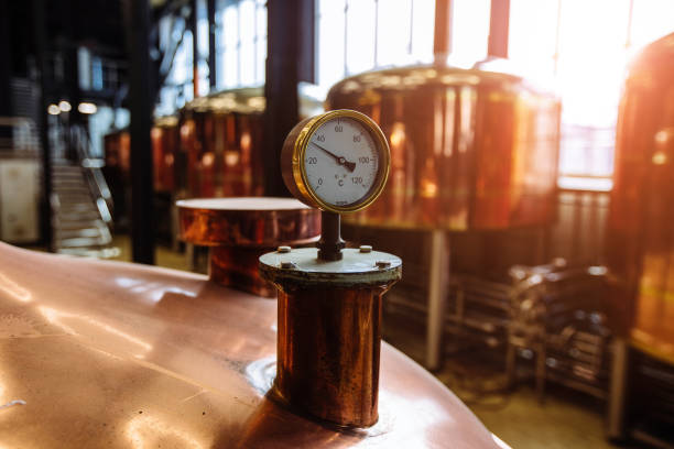 istock Thermometer or pressure gauge on copper colored brewery tanks close up. 1389977683