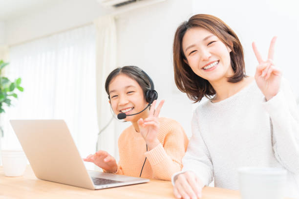 istock girl studying with a PC,correspondence course, mother and daughter 1389979497