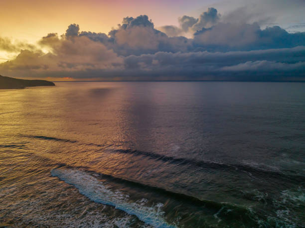 istock Sunrise seascape with rain clouds on the horizon 1389980423