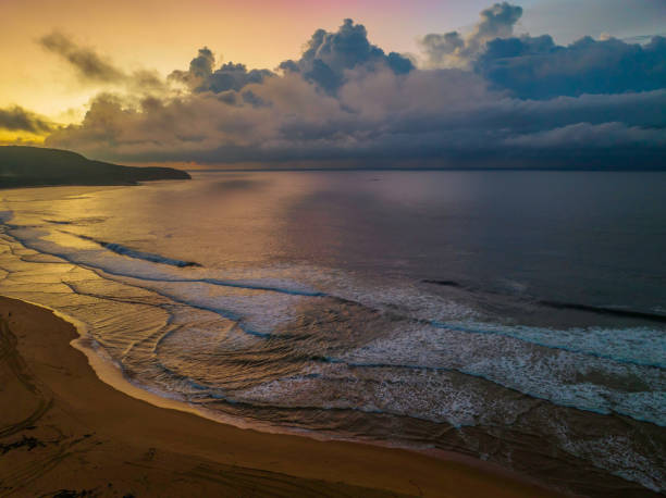 istock Sunrise seascape with rain clouds on the horizon 1389980431