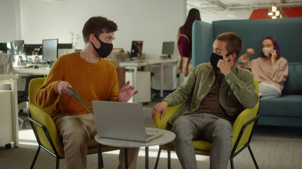 istock One of the students meets his classmate and they start discussing their project 1389986754