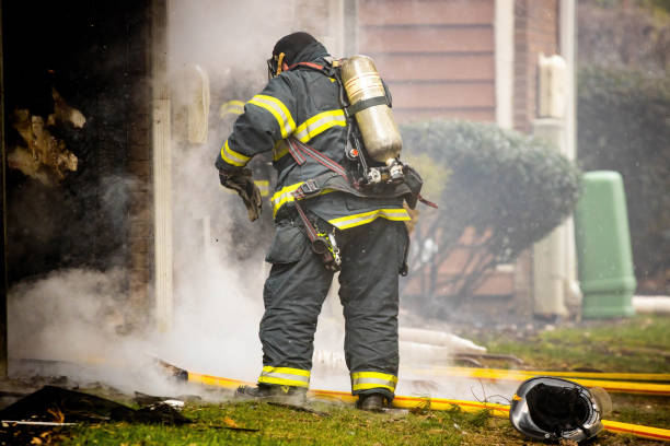 istock Firefighter wearing protective gear and oxygen mask 1389989273