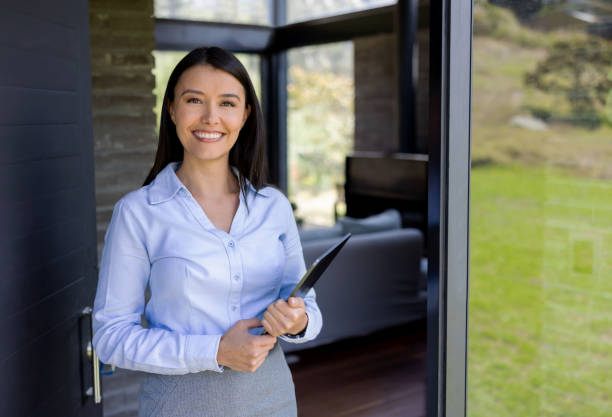istock Happy real estate agent showing a house 1389993874