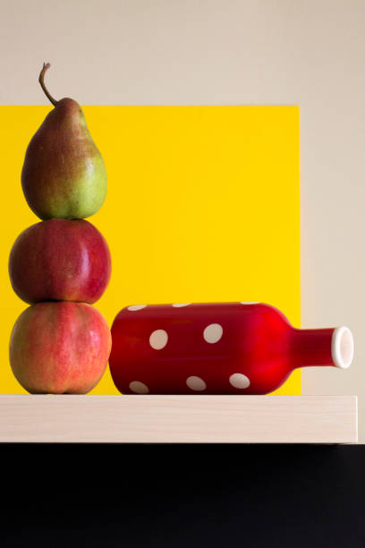 Still life with apples and pears and a red vase on a shelf