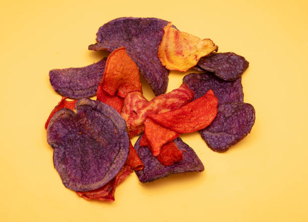 Colorful potato chips pile on yellow stock photo