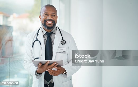 istock Shot of a mature doctor using a digital tablet in a modern hospital 1390000431