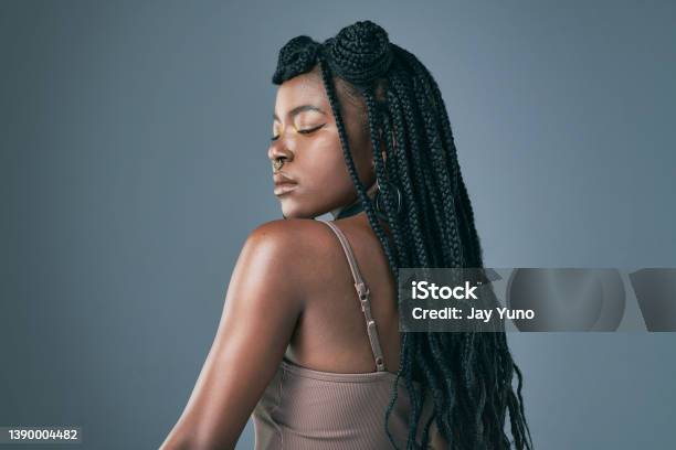 Studio Shot Of A Trendy Young Woman Posing Against A Grey Background Stock Photo - Download Image Now