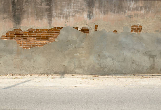 istock old cement wall background with cracks and road 1390010650