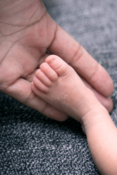 istock tiny foot of newborn baby 1390011137