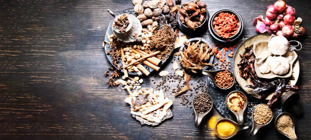 istock Banner web Thai native food, spices herbs, and various ingredients taken top view angle. Group of hot and spicy dry vegetables, nuts, on wooden dark tone background 1390011800