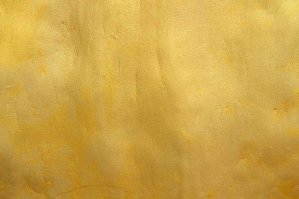 istock Gold color old grunge wall concrete texture as background. 1390012249