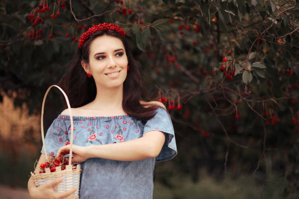 istock Beautiful Young Woman Picking Cherries in May 1390013821