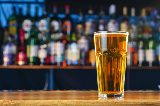 istock Fresh cold beer in glass on bar background 1390014767