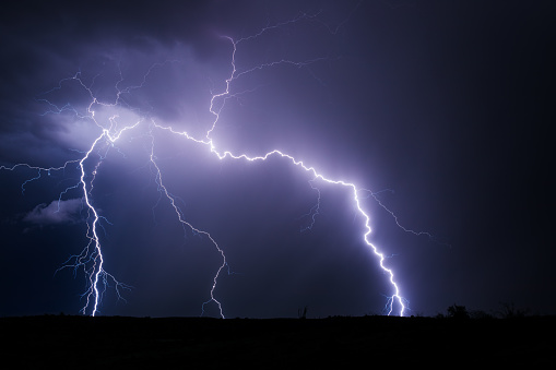 A thunderstorm with lightning bolt strikes in the night sky near Phoenix, Arizona.