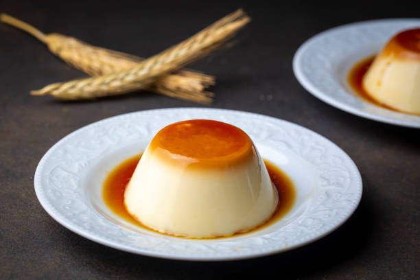 istock Cream caramel pudding with caramel sauce in plate on white rustic table 1390017047