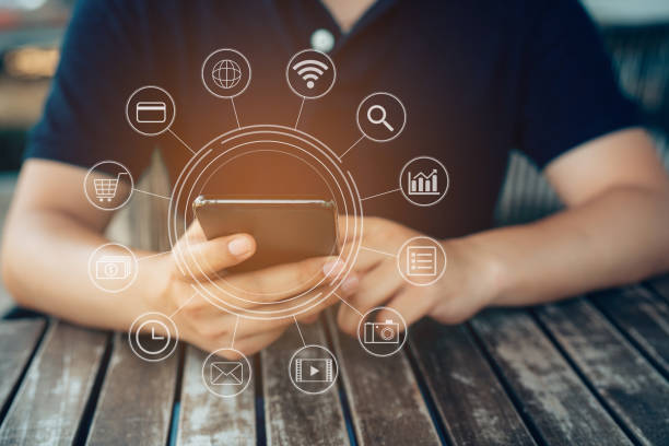 istock Hand holding smart phone payments online shopping with graphic icon customer network connection on screen. 1390019384