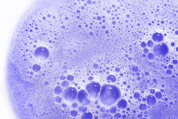 Purple blonde dye hair shampoo texture isolated on white background. Foam of violet cooling shampoo or conditioner for blonde hair.