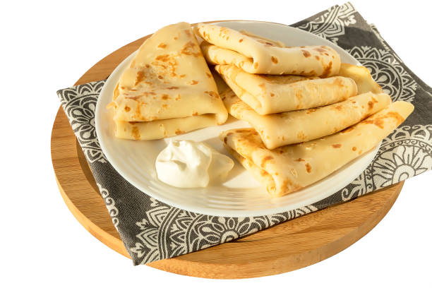 istock Freshly cooked delicious appetizing fried pancakes with sour cream on a white plate. 1390024883