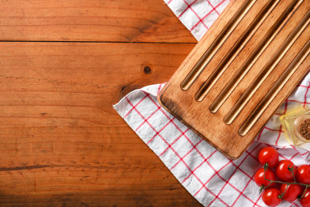Overhead shot, Empty wooden board with fresh tomatoes on white and red table cloth, copy space on wooden background.