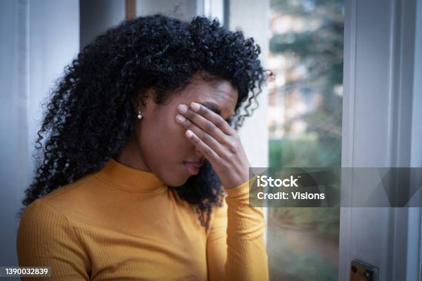 One Black Woman Depressed In Front Of Window Stock Photo - Download Image Now - Black People, Depression - Sadness, Anxiety