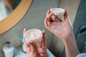 Unrecognizable young woman holding the face powder