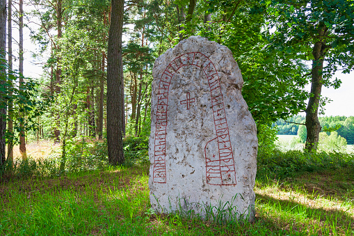 Falköping, Sweden - July 21, 2017: Old rune stone in a forest