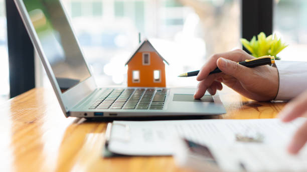 businessman, contract signing or accountant working on financial investments. using a calculator financial documents analyze the report real estate and home loan insurance - vastgoed stockfoto's en -beelden