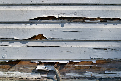 Wooden house wall background with old peeling paint