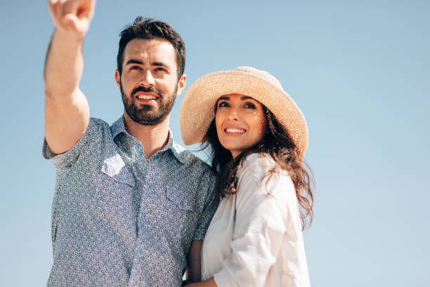 istock couple rear view walking on the beach 1390038758