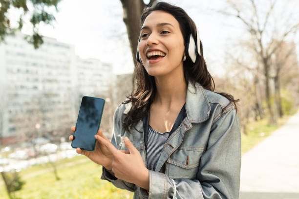 istock Girl in a walk having fun with music 1390039877