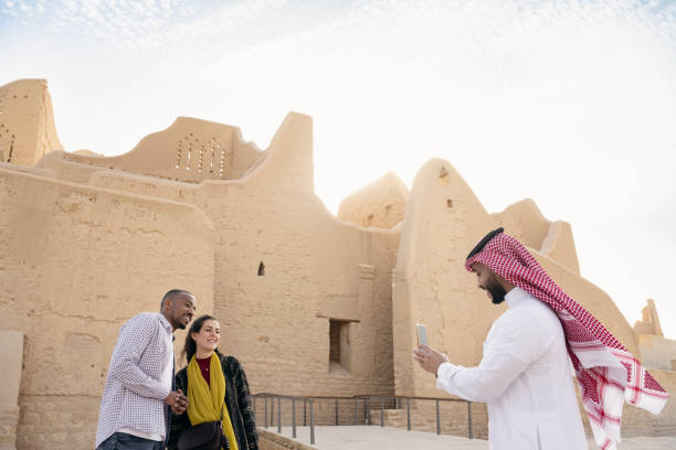 Saudi guide photographing tourists in front of Salwa Palace