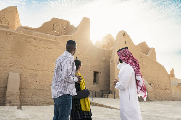 Saudi guide educating tourists about history of Salwa Palace