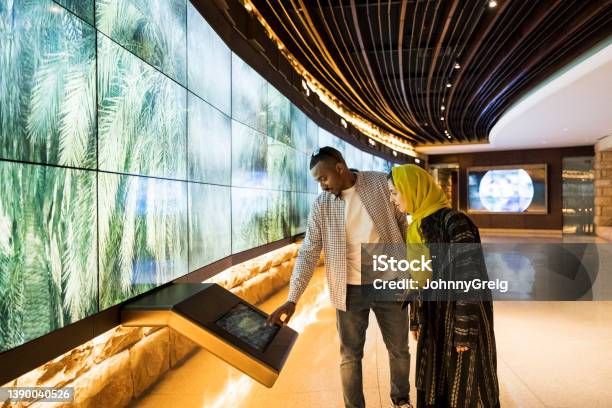 Tourists Using Technology In Atturaif Visitors Centre Stock Photo - Download Image Now