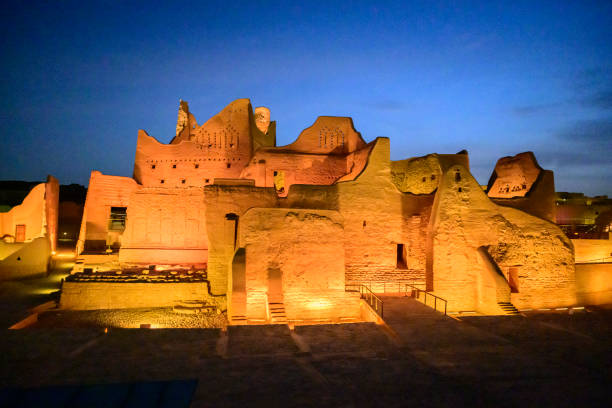 Salwa Palace at twilight Wide angle view of At-Turaif open air museum and UNESCO World Heritage Site near Riyadh, mud-brick architecture illuminated under blue hour sky. Property release attached. national heritage site stock pictures, royalty-free photos & images