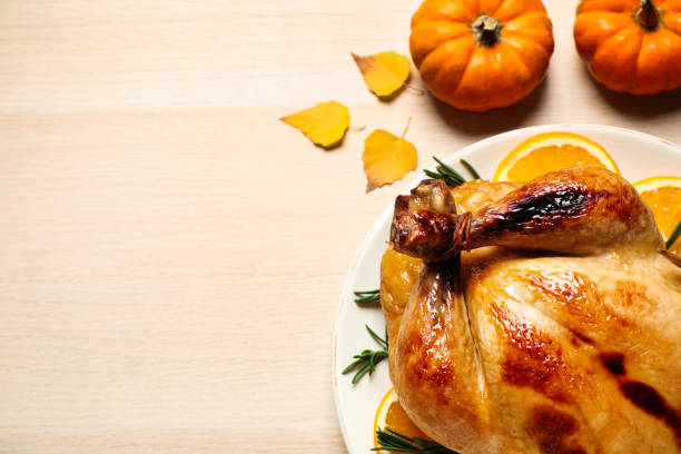 istock Traditional cooked turkey and autumn decor on wooden table, flat lay with space for text. Thanksgiving day celebration 1390041435