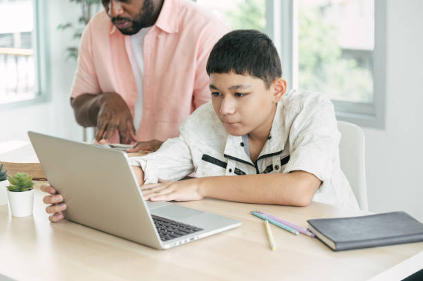 istock Boy learning class with tutor teacher and laptop computer at home 1390041833