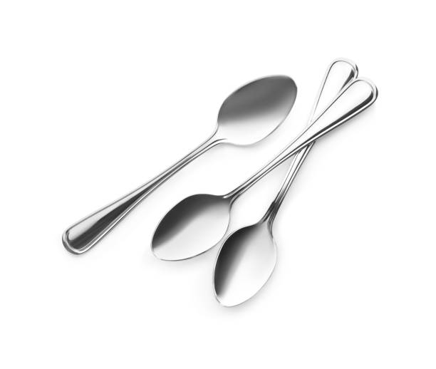 istock Clean shiny metal spoons on white background, top view 1390042948