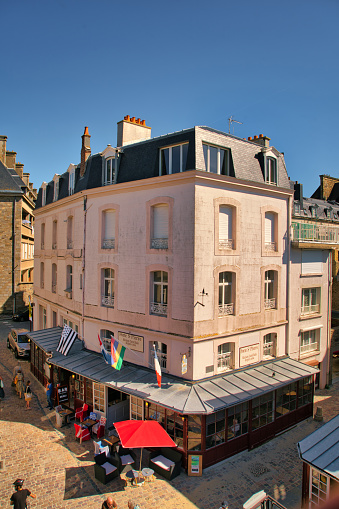 Saint-Malo, France, August 30, 2019: Summer day at the famous city of Saint-Malo. It is a historic French port in Ille-et-Vilaine, Brittany on the English Channel coast. The city had a long history of piracy, earning much wealth from local extortion and overseas adventures. The city changed into a popular tourist centre, with a ferry terminal serving the Channel Islands of Jersey and Guernsey, as well as the Southern English settlements of Portsmouth, Hampshire and Poole, Dorset.